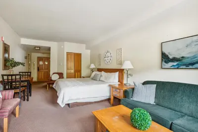 a hotel room with a bed and a couch at Cozy Ski-In Ski-Out Condo with Heated Pool in Keystone