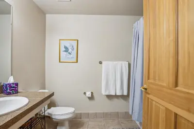 a bathroom with a toilet and a sink at Cozy Ski-In Ski-Out Condo with Heated Pool in Keystone