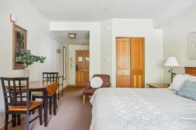 a bedroom with a bed and a table and chairs at Cozy Ski-In Ski-Out Condo with Heated Pool in Keystone