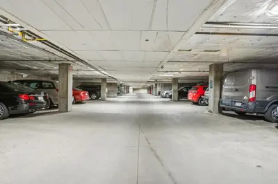 a large parking garage with cars parked in it at Cozy Ski-In Ski-Out Condo with Heated Pool in Keystone