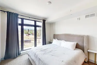 a bedroom with a bed and a large window at Timber Fox Escape in Winter Park
