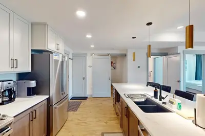 a kitchen with white cabinets and a counter top at Timber Fox Escape in Winter Park