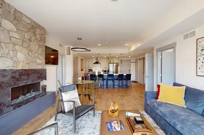a living room with a couch and a fireplace at Timber Fox Escape in Winter Park