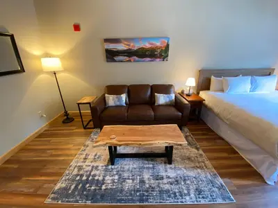 a bedroom with a bed and a couch and a coffee table at Gateway Lodge 5003 by SummitCove Lodging in Keystone