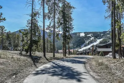 a road with trees on the side of a mountain at Gateway Lodge 5003 by SummitCove Lodging in Keystone
