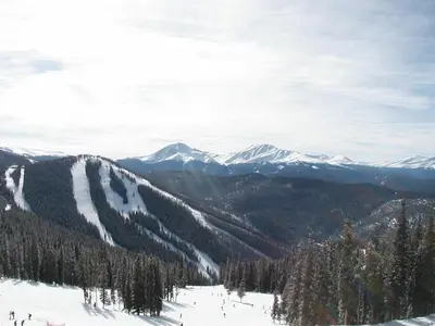 a group of people skiing down a snow covered mountain at Gateway Lodge 5037 by SummitCove Lodging in Keystone