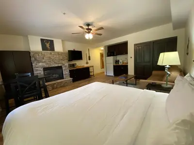 a bedroom with a white bed and a fireplace at Gateway Lodge 5037 by SummitCove Lodging in Keystone