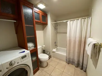 a small bathroom with a washer and a toilet at Gateway Lodge 5037 by SummitCove Lodging in Keystone