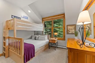 a bedroom with a bunk bed and a desk at Ski Tip 8709 : 2 in Keystone