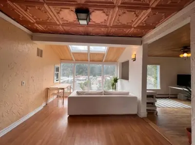 a large living room with a couch and a table at 3 Bedroom - Awesome Views, Light, Deck in Idaho Springs