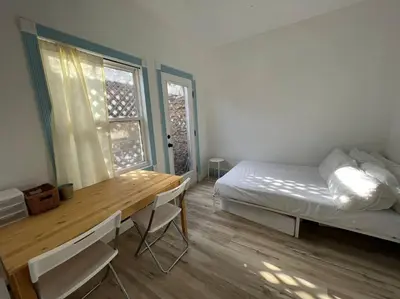 a bedroom with a bed and a desk and a table at 3 Bedroom - Awesome Views, Light, Deck in Idaho Springs
