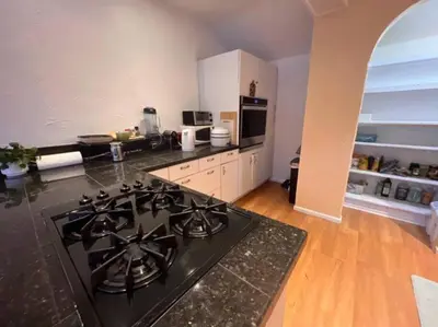 a kitchen with a black stove top oven at 3 Bedroom - Awesome Views, Light, Deck in Idaho Springs