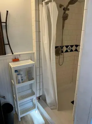 a bathroom with a shower with a white shower curtain at 3 Bedroom - Awesome Views, Light, Deck in Idaho Springs