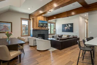 a living room with a couch and a fireplace at Aprez Retreat condo in Winter Park