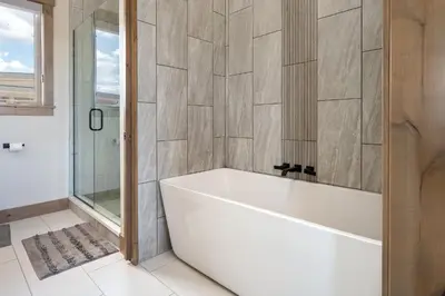 a white bath tub in a bathroom with a shower at Aprez Retreat condo in Winter Park