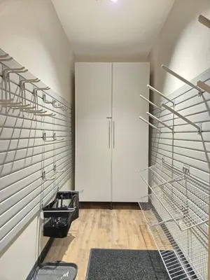 a walk in closet with white cabinets and metal racks at Aprez Retreat condo in Winter Park