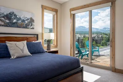 a bedroom with a bed and a sliding glass door at Aprez Retreat condo in Winter Park