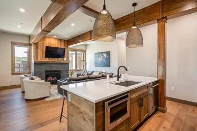 a kitchen with a sink and a living room at Aprez Retreat condo in Winter Park