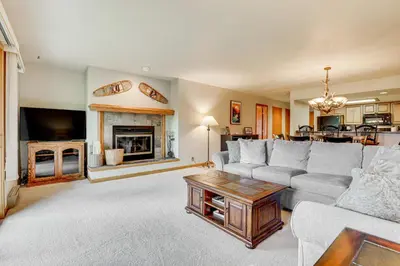 a living room with a couch and a fireplace at Steps to Shadow Mountain Lake Grand Lake Condo in Grand Lake