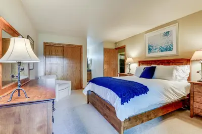 a bedroom with a large bed and a desk at Steps to Shadow Mountain Lake Grand Lake Condo in Grand Lake