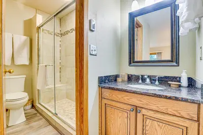 a bathroom with a toilet sink and a shower at Steps to Shadow Mountain Lake Grand Lake Condo in Grand Lake
