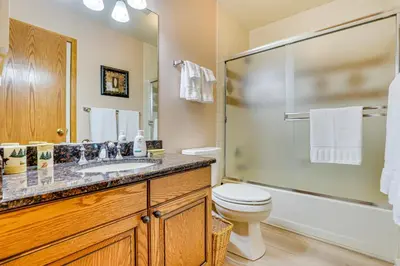 a bathroom with a sink and a shower and a toilet at Steps to Shadow Mountain Lake Grand Lake Condo in Grand Lake