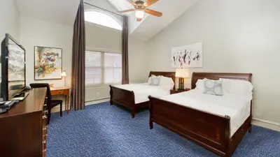 a hotel room with two beds and a television at The Bradley Boulder Inn in Boulder