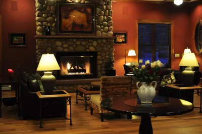 a living room with a fireplace and a table at The Bradley Boulder Inn in Boulder