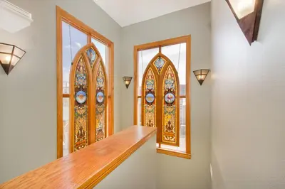 a hallway with two stained glass windows and a staircase at The Bradley Boulder Inn in Boulder