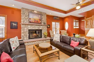 a living room with leather furniture and a fireplace at The Bradley Boulder Inn in Boulder