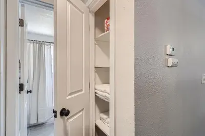 a closet with a door open to a room at 4BD - Hot Tub, BBQ, Games - 10 Mins to Olde Town in Arvada