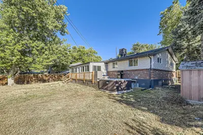an empty yard with a house and a fence at 4BD - Hot Tub, BBQ, Games - 10 Mins to Olde Town in Arvada