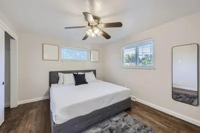a bedroom with a bed and a ceiling fan at 4BD - Hot Tub, BBQ, Games - 10 Mins to Olde Town in Arvada