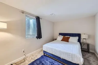 a bedroom with a bed and a window at 4BD - Hot Tub, BBQ, Games - 10 Mins to Olde Town in Arvada