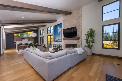 a living room with a large couch and a fireplace at Cloud N9NE Chalet in Fraser