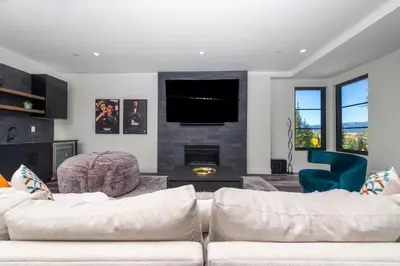 a living room with a couch and a fireplace at Cloud N9NE Chalet in Fraser