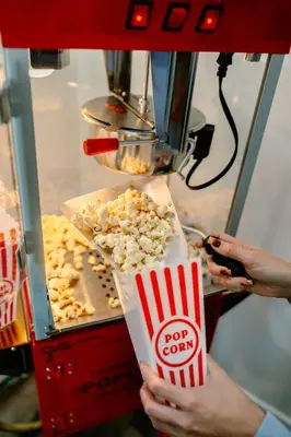 a person is preparing popcorn in a popcorn machine at Cloud N9NE Chalet in Fraser