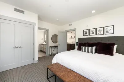 a bedroom with a large white bed with a bench at Timber Fox 1208 apts in Winter Park