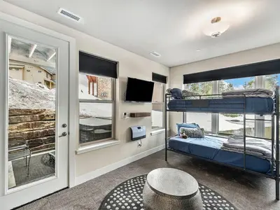 a bedroom with two bunk beds and a window at Rendezvous - 99 Stagecoach in Fraser