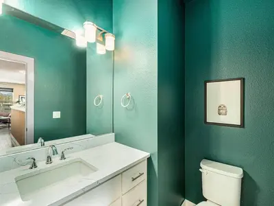 a bathroom with a toilet and a sink and a mirror at Rendezvous - 99 Stagecoach in Fraser