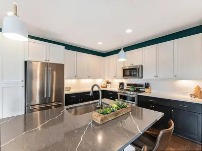 a kitchen with a sink and a stainless steel refrigerator at Rendezvous - 99 Stagecoach in Fraser