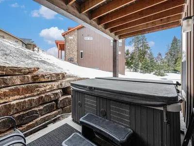 a hot tub on the patio of a house at Rendezvous - 99 Stagecoach in Fraser