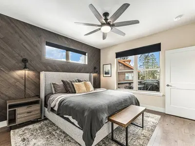 a bedroom with a bed and a ceiling fan at Rendezvous - 99 Stagecoach in Fraser