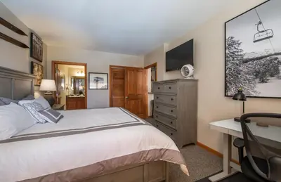 a bedroom with a bed and a desk at Value Unit 1422 - 2BR - Zephyr Mountain Lodge condo in Winter Park