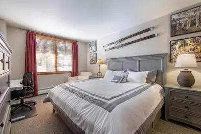 a bedroom with a bed and a desk and a chair at Value Unit 1422 - 2BR - Zephyr Mountain Lodge condo in Winter Park