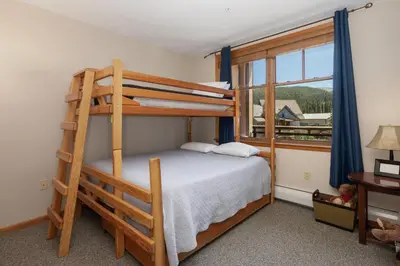 a bedroom with two bunk beds and a window at Value Unit 1422 - 2BR - Zephyr Mountain Lodge condo in Winter Park