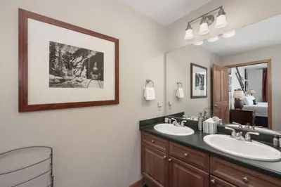 a bathroom with two sinks and a mirror at Value Unit 1422 - 2BR - Zephyr Mountain Lodge condo in Winter Park
