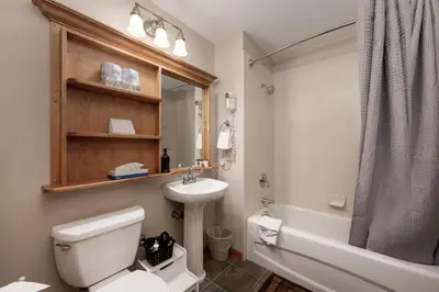a bathroom with a toilet and a sink and a tub at Value Unit 1422 - 2BR - Zephyr Mountain Lodge condo in Winter Park