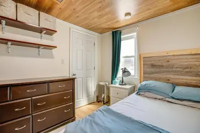 a bedroom with a bed and a dresser and a window at Aurora Abode 7 Mi to Dtwn Denver! in Aurora