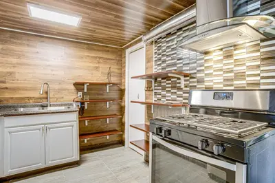 a kitchen with a stove and a sink at Aurora Abode 7 Mi to Dtwn Denver! in Aurora